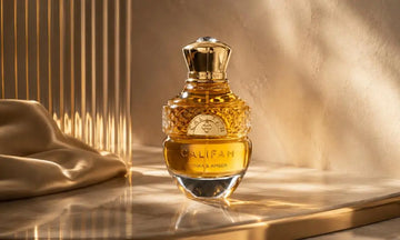 Luxury amber perfume bottle on a marble surface with warm golden lighting, soft satin fabric, and an elegant textured backdrop.