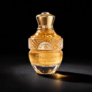 CALIFAH Patchouli Leather perfume bottle with a gold cap and faceted glass detailing against a black background.