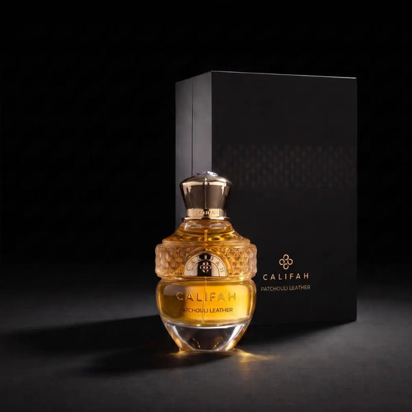 Luxury CALIFAH Patchouli Leather Parfum bottle displayed beside its elegant black box on a dark background with warm golden lighting.