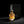 Califah Patchouli Rose Parfum bottle with a textured gold cap and golden amber liquid, positioned in front of a tall black branded box on a dark studio background.