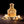 CALIFAH Patchouli Leather perfume bottle surrounded by cream rose petals on a brown textured surface.