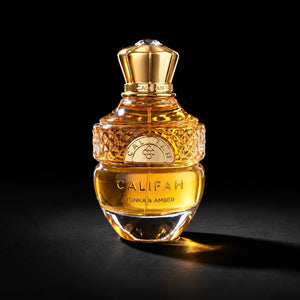 CALIFAH Tonka & Amber perfume bottle with amber liquid, faceted glass detailing and a gold cap against a black background.