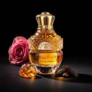 CALIFAH Tonka & Amber perfume bottle surrounded by tonka beans, an amber stone and a pink rose.
