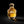 A bottle of Califah Tonka & Amber Parfum with a textured gold cap and golden liquid inside a clear glass bottle, set against a solid black background.