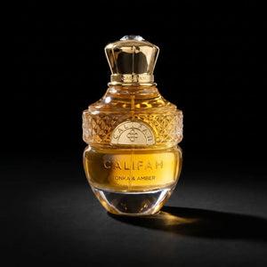 A bottle of Califah Tonka & Amber Parfum with a textured gold cap and golden liquid inside a clear glass bottle, set against a solid black background.