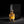 A bottle of Califah Tonka & Amber Parfum with golden amber liquid and a textured gold cap, displayed in front of its black packaging box on a dark background.